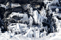 The massive fire at Northern Metal recycling in Becker, Minnesota, that has been burning for days, seemed to be under control Thursday, Feb. 20, 2020 with massive piles of burned cars covered in ice. The Becker Police Department posted Thursday that “major progress' has been made and that fire crews report the fire is “under control at this point.”