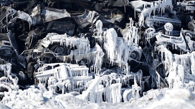 The massive fire at Northern Metal recycling in Becker, Minnesota, that has been burning for days, seemed to be under control Thursday, Feb. 20, 2020 with massive piles of burned cars covered in ice. The Becker Police Department posted Thursday that “major progress' has been made and that fire crews report the fire is “under control at this point.”