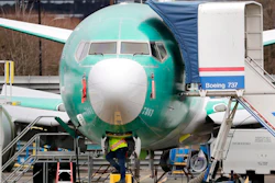 In this Dec. 16, 2019, file photo a worker looks up underneath a Boeing 737 MAX jet in Renton, Wash. Boeing sold no new airline jets in January, and now the company is worried that the virus outbreak in China could hurt airplane deliveries in the first quarter.