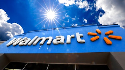 This June 25, 2019, file photo shows the entrance to a Walmart in Pittsburgh. Walmart is reporting disappointing fourth-quarter profits and sales. The nation's largest retailer says that sales at its U.S. stores heading into the holiday season were weaker than expected. It also said that social unrest in Chile hurt its business.
