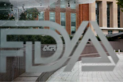 U.S. Food and Drug Administration building behind FDA logos at a bus stop on the agency's campus in Silver Spring, Md.