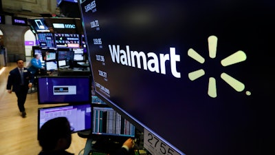 In this Feb. 18, 2020 file photo, the logo for Walmart appears above a trading post on the floor of the New York Stock Exchange.