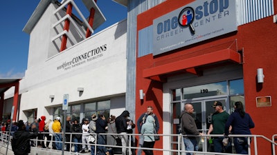 People wait in line for help with unemployment benefits at the One-Stop Career Center, Tuesday, March 17, 2020, in Las Vegas.