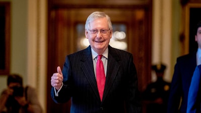 Senate Majority Leader Mitch McConnell of Ky. gives a thumbs up as he leaves the Senate chamber on Capitol Hill in Washington, Wednesday, March 25, 2020