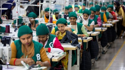 In this April 19, 2018 file photo, trainees work at Snowtex garment factory in Dhamrai, near Dhaka, Bangladesh.