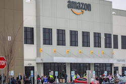 In this March 30, 2020 file photo, workers at Amazon's fulfillment center in Staten Island, N.Y., gather outside to protest work conditions in the company's warehouse in New York.