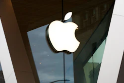 In this Saturday, March 14, 2020 file photo, an Apple logo adorns the facade of the downtown Brooklyn Apple store in New York. Apple’s new iPad brings PC-like trackpad capabilities for the first time, as the company seeks to make its tablet even more like a laptop computer. Apple says the trackpad will offer more precision than fingers in selecting text and switching between apps.
