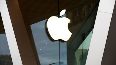 In this Saturday, March 14, 2020 file photo, an Apple logo adorns the facade of the downtown Brooklyn Apple store in New York. Apple’s new iPad brings PC-like trackpad capabilities for the first time, as the company seeks to make its tablet even more like a laptop computer. Apple says the trackpad will offer more precision than fingers in selecting text and switching between apps.