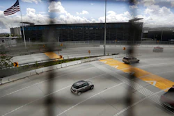 A few cars head south to cross from San Diego into Tijuana, Mexico, through what is normally one of the world's busiest land border crossings, Thursday, March 19, 2020, in San Diego.