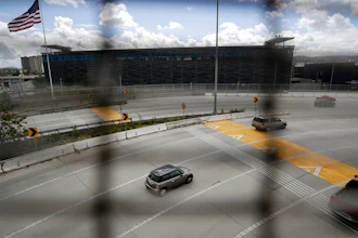 A few cars head south to cross from San Diego into Tijuana, Mexico, through what is normally one of the world's busiest land border crossings, Thursday, March 19, 2020, in San Diego.