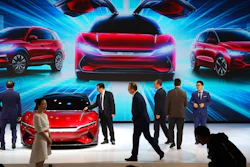 In this April 16, 2019, file photo, attendees take a close look at cars from BYD at the Auto Shanghai 2019 show in Shanghai. China’s auto sales plunged 81.7% in February, 2020, from a year ago after Beijing shut down much of the economy to fight a virus outbreak, adding to problems for an industry that already was struggling with shrinking demand.