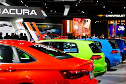 In a Jan. 15, 2019 file photo, signage for automakers Volkswagen, Acura, Chevrolet and Ford, at the North American International Auto Show in Detroit. The North American International Auto Show said that it will cancel its Detroit show because of the coronavirus pandemic.