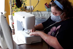 In this photo taken on Thursday, March 19, 2020, Sien Lagae, works on a mouth mask, meant to help protect from the spread of COVID-19, on her sewing machine at home in Torhout, Belgium. Lagae runs a social media group of volunteers who are making mouth masks for family and friends as well as hospital and caregivers in Belgium due to a shortage in supply of industrially made masks. For most people, the new coronavirus causes only mild or moderate symptoms, such as fever and cough. For some, especially older adults and people with existing health problems, it can cause more severe illness, including pneumonia.