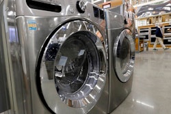 In this Jan. 27, 2020 file photo a clothes washer, left, and dryer, center, are on display at a Home Depot store location, in Boston. Orders to U.S. factories for big-ticket manufactured goods rose by a solid amount in February 2020, but the gain came before the coronavirus had shut down much of the country. The Commerce Department said Wednesday, March 25, durable goods orders rose 1.2% last month, rebounding from January when orders had shown a tiny 0.1% gain.