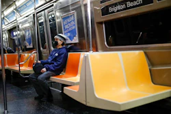 A commuter wears a face mask while riding the a nearly empty subway car into Brooklyn, Thursday, March 12, 2020, in New York. New York City Mayor Bill de Blasio said Thursday he will announce new restrictions on gatherings to halt the spread of the new coronavirus in the coming days, but he hopes to avoid closing all public events such as Broadway shows. For most people, the new coronavirus causes only mild or moderate symptoms. For some it can cause more severe illness.