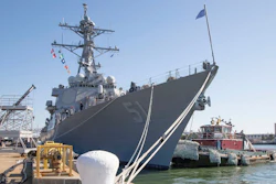 A tug boat pulls along side the guided missile destroyer USS Arleigh Burke (DDG 51) as the ship prepares to get underway for sea trials in January.