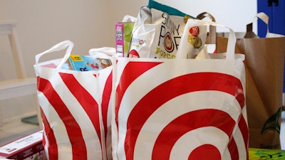 In this Sunday, March 29, 2020, photo, groceries loaded in plastic bags are seen after a shopping trip in Portland, Ore.