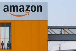 Employees observe social distancing due to coronavirus, at the entrance of Amazon, in Douai, northern France.