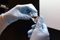 In this March 2020 photo provided by Gilead Sciences, a vial of the investigational drug remdesivir is visually inspected at a Gilead manufacturing site in the United States. Given through an IV, the medication is designed to interfere with an enzyme that reproduces viral genetic material.