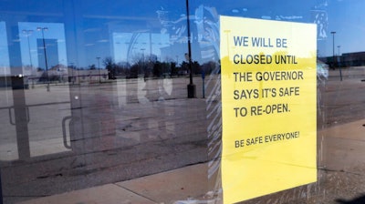 A closed sign is shown at Romeo & Juliet Furniture and Appliances with an empty parking lot in Detroit, Thursday, April 2, 2020. The coronavirus COVID-19 outbreak has triggered a stunning collapse in the U.S. workforce with 10 million people losing their jobs in the past two weeks and economists warn unemployment could reach levels not seen since the Depression, as the economic damage from the crisis piles up around the world.