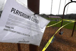 A sign announces another playground closed due to coronavirus concerns as caution tape is wrapped around the swings at Ohio Township Community Park, Tuesday, April 7, 2020, in Ohio Township, Pa.