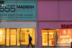 In this Thursday, March 19, 2020, photo, a pedestrian walks past a storefront for rent on Madison Avenue, in New York. Long before there was a global pandemic, brick-and-mortar retailers struggled to resonate as shoppers increasingly made their purchases online. Now, they're faced with an even more daunting task of staying on people's minds and pocketbooks in the midst of the new coronavirus.