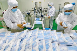 Workers pack surgical masks at a factory in Suining city in southwest China's Sichuan province.