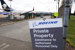 In this April 20, 2020, file photo, planes sit parked behind a sign marking Boeing property at a Boeing production plant in Renton, Wash. Boeing shareholders approved a slate of 12 company-backed nominees for the board on Monday, April 27, despite recommendations from two proxy advisers against five directors, including the chairman, for what the advisers called poor oversight of the company's handling of the 737 Max crisis.