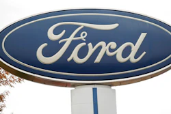 In this Oct. 20, 2019, file photo, the company logo stands over a long row of unsold vehicles at a Ford dealership in Littleton, Colo. Ford Motor Co. posted a $2 billion first-quarter net loss, blaming nearly all of it on the negative effects of the coronavirus.