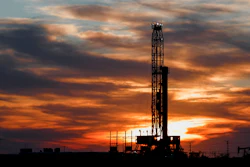 An oil rig stands against the setting sun in Midland, Texas.