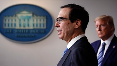 President Donald Trump listens as Treasury Secretary Steven Mnuchin speaks about the coronavirus.