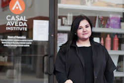 Christa Schall poses outside her cosmetology school, Casal Aveda Institute.