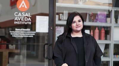Christa Schall poses outside her cosmetology school, Casal Aveda Institute.