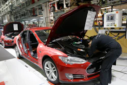 Tesla employees work on Model S cars in the Tesla factory in Fremont, Calif., May 14, 2015.