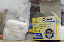 An opened box of protective masks sits on a pallet at Direct Relief's distribution center in Santa Barbara, Calif.