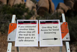 Signs advise visitors to social distance at Joshua Tree National Park in California.