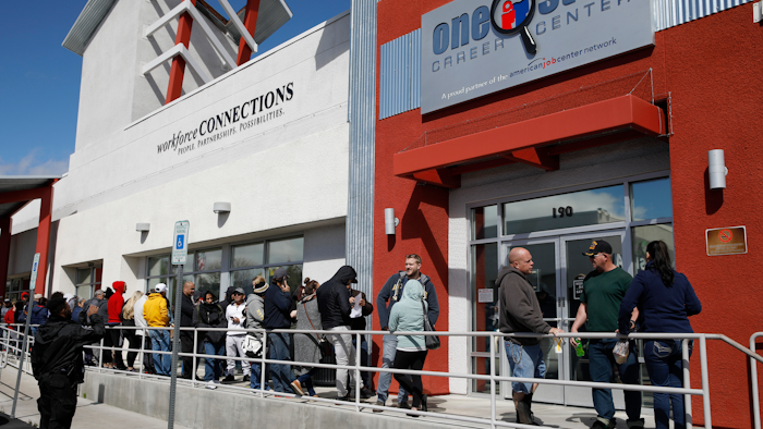 People wait in line for help with unemployment benefits in Las Vegas, NV.