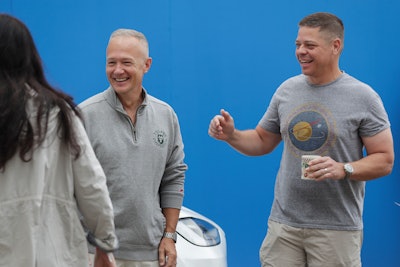 NASA astronauts Douglas Hurley, left, and Robert Behnken smile outside the Neil A. Armstrong Operations and Checkout Building