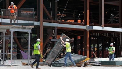 Workers build a protective barrier as construction resumed on the New York Islanders' new arena, located adjacent to Belmont race track, during the current coronavirus outbreak on Wednesday, May 27 in Elmont, NY.