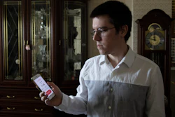 Vladimir Perevalov shows a Social Monitoring app installed on his phone in his apartment in Shcherbinka, outside Moscow, May 27, 2020.