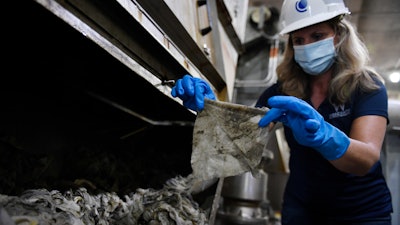 WSSC Water spokesperson holds up a wipe that was collected along with other debris at a pumping station.