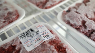 Packages of meat sit in a cooler at a local super market.