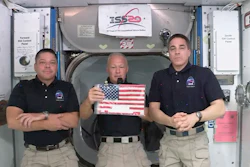 ASA astronauts Robert L. Behnken, left, and Chris Cassidy right, listen as commander Douglas Hurley speaks about retrieving the American flag left behind at the International Space Station nearly a decade ago.