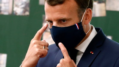 French President Emmanuel Macron wears a protective face mask.