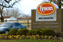 In this Jan. 29, 2006 photo, a car passes in front of a Tyson Foods sign at the company's headquarters in Springdale, Ark. China's decision to ban imports from a single Tyson Foods poultry plant because of concerns about a coronavirus outbreak there puzzled many in the meat industry and raised concerns about whether this could threaten a major market for U.S. meat.