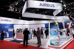In this Tuesday, Feb. 11, 2020 file photo, visitors are seen at the booth of Airbus during the opening trade day of the Singapore Airshow 2020 in Singapore. European aircraft manufacturer Airbus says it plans to shed 15,000 jobs over the next year, with jobs mostly being lost in Europe. Airbus is struggling with the financial hit of the coronavirus pandemic. It said Tuesday, June 30 that it doesn't expect air traffic to recover to pre-COVID levels before 2023 and potentially as late as 2025.