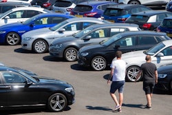 People view cars on the forecourt of a car sales outlet, in Norfolk, England, open for the first time since the lockdown, as part of a wider easing of restrictions in England, Monday June 1, 2020. The British government has lifted some lockdown restrictions to restart social life and activate the economy while still endeavouring to limit the spread of the highly contagious COVID-19 coronavirus.