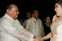 In this June 19, 2011, file photo, San Miguel Corporation chairman Eduardo Cojuangco Jr., left, greets then congresswoman Imelda Marcos, the widow of the late strongman Ferdinand Marcos, during the 40th wedding anniversary of Philippine Senator Miriam Santiago and Narciso at Manila's Cathedral in Philippines. Philippine tycoon Cojuangco, a key ally of the late dictator Ferdinand Marcos and a low-key businessman who led a food and beverage empire that produced San Miguel beer, has died Tuesday night, June 16, 2020. He was 85.