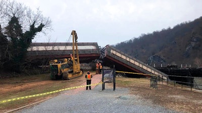 This Dec. 21, 2019 file photo photo provided by the Washington County, Md., shows a freight line train in the Potomac River near Harpers Ferry, W.Va. A report from the Federal Railroad Administration says an engineer error caused a CSX freight train to derail as it crossed the Potomac River near Harpers Ferry, West Virginia. The derailment in December sent two cars into the water and damaged a footbridge that is part of the Appalachian Trail