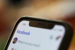 An iPhone displays a Facebook page in New Orleans, Aug. 11, 2019.